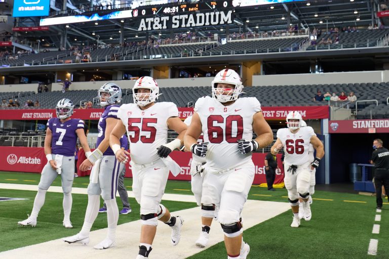 Stanford football's Drake Metcalf and Drake Nugent jog onto the field at AT&T Stadium.