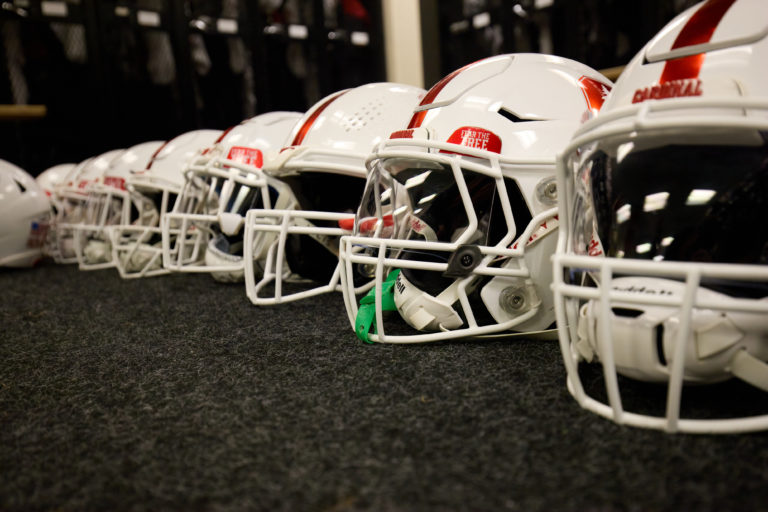 Stanford football helmets arranged in a line.