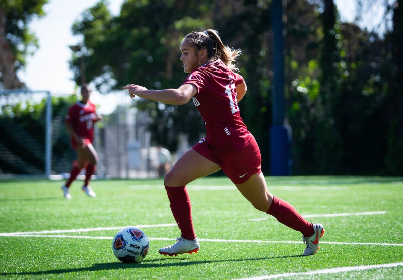 Stanford soccer player Jojo Harber brings the ball down the field in a soccer match.