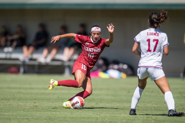 Maya Doms dribbles the ball by a defender.