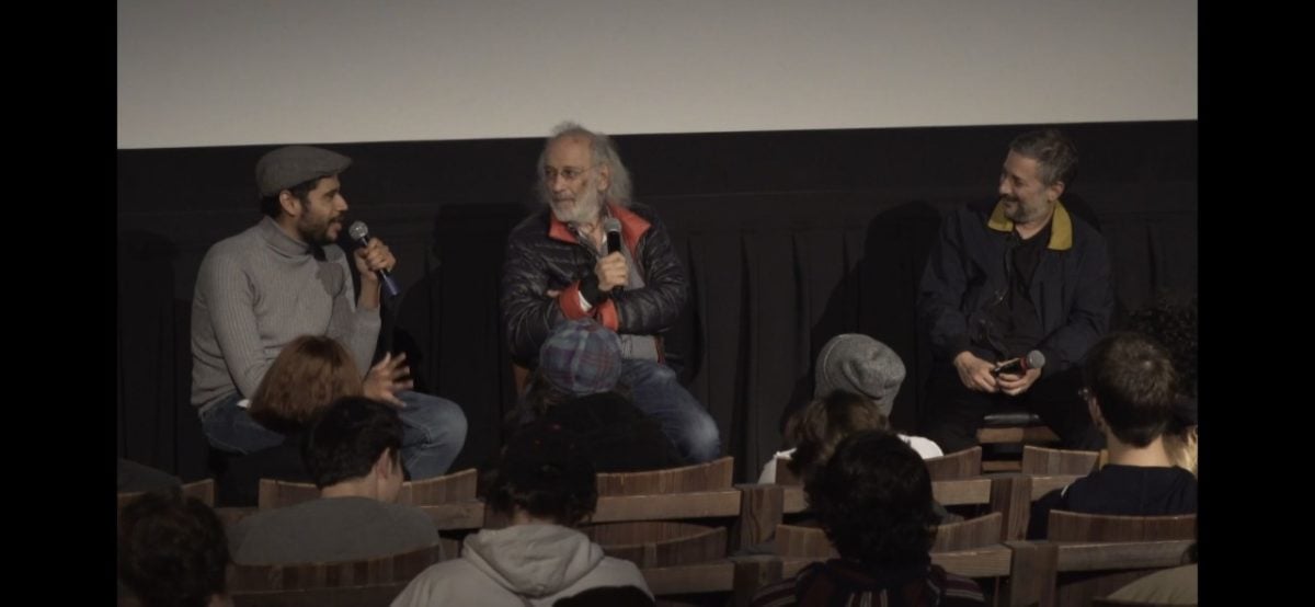 Three men discussing film at an event