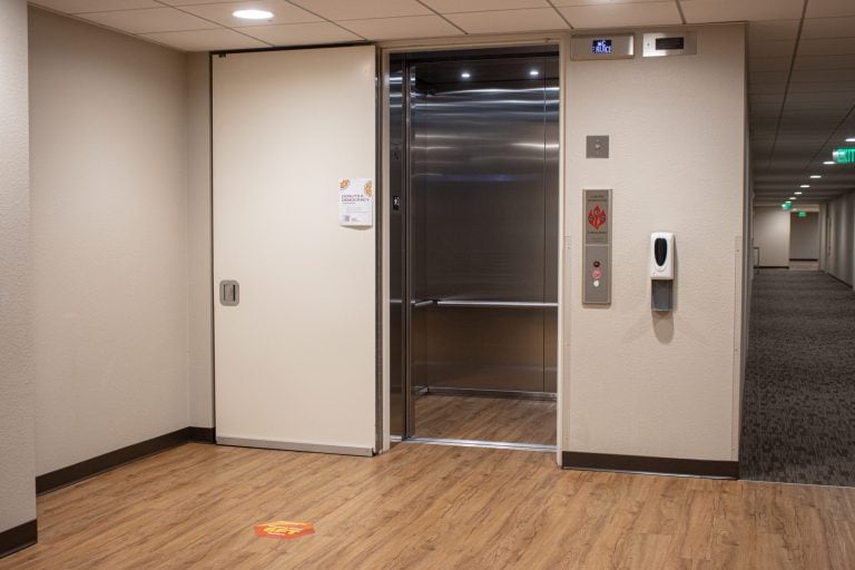 Bare walls on either side of an elevator in EVGR A.