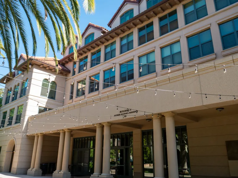 Building with a palm tree in front of it