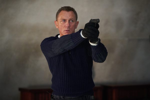 Daniel Craig as James Bond pointing a gun