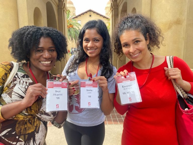 Three Stanford alumnae pose with their identification badges.