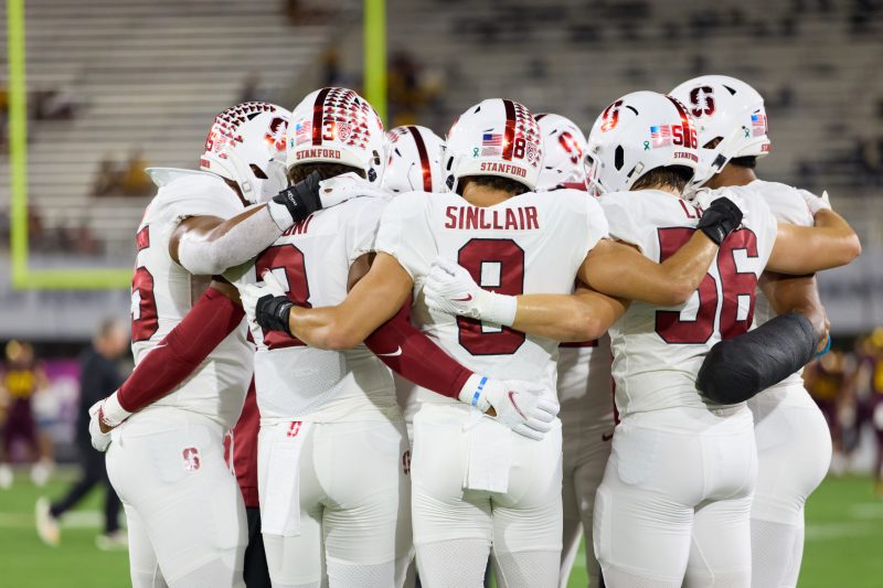 The inside linebackers of the Stanford Cardinal huddle before a game at Arizona State University.