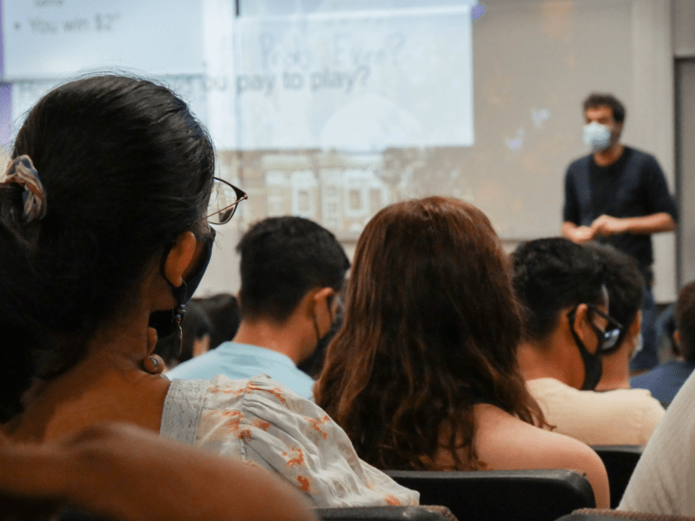 Masked students attend in-person class.