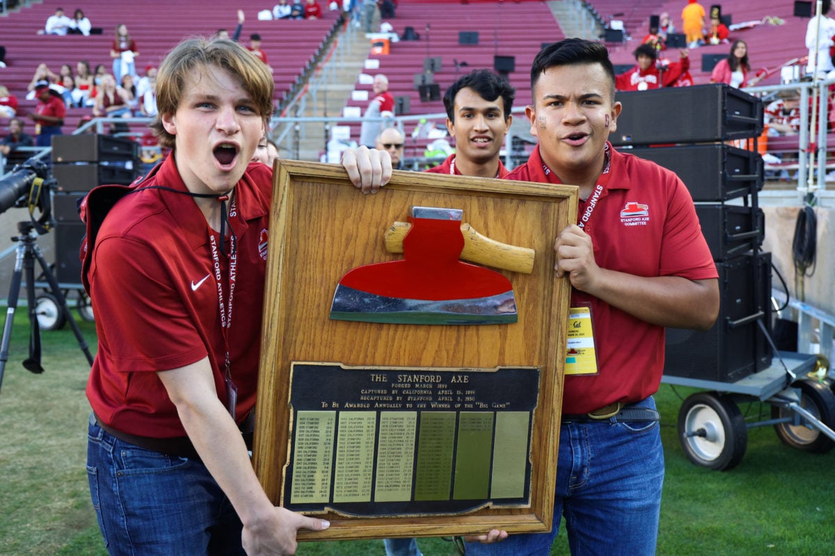 Two Axe Committee members hold The Stanford Axe.