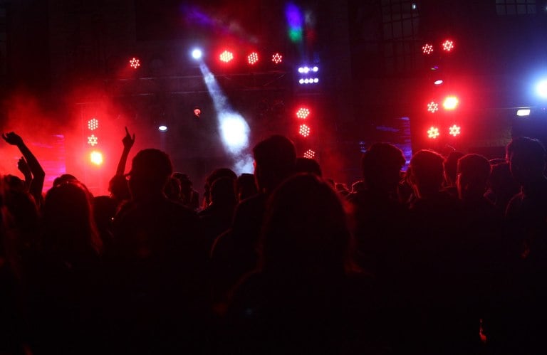 A nightclub with lights and people dancing.