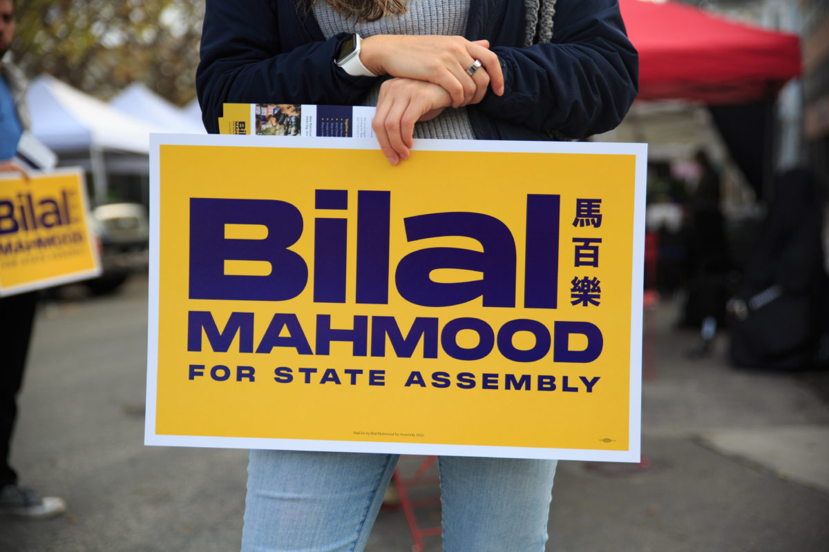 Yellow sign with blue text that says Bilal Mahmood For State Assembly