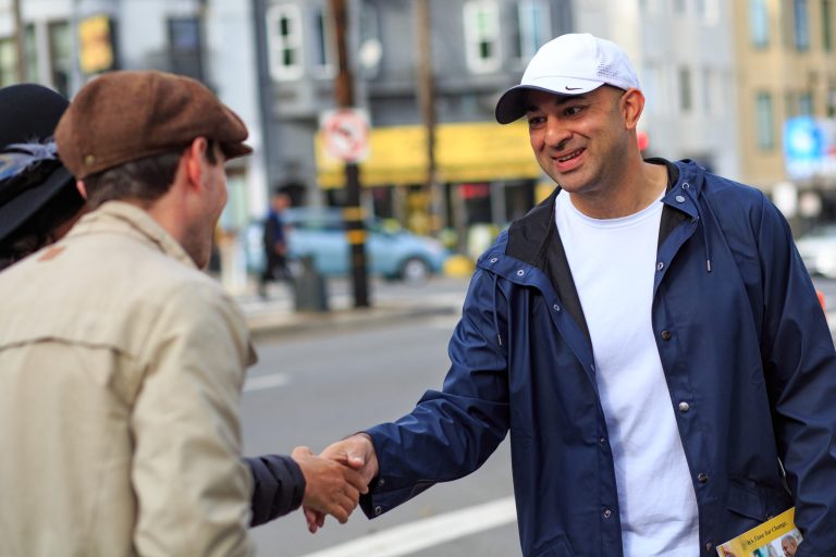 A photo of Mahmood shaking a hand