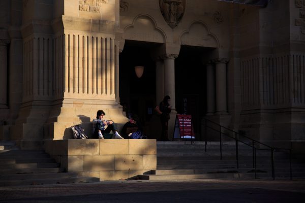 Two Students sitting outside of Green Library