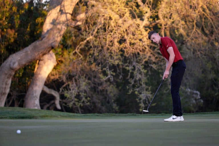 Junior Barclay Brown watches his putt roll toward the hole.