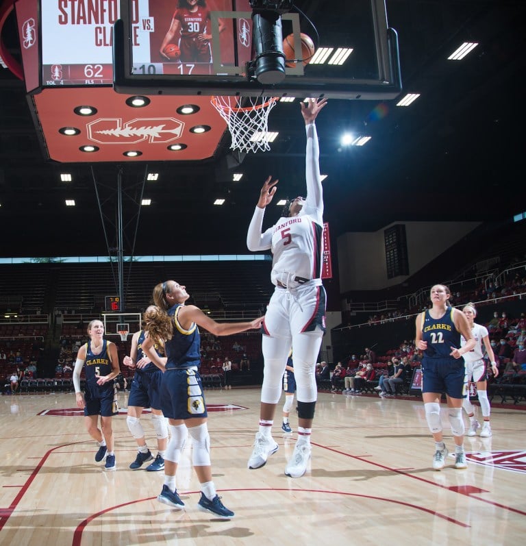 Junior forward Francesca Belibi touches the backboard as she makes a layup.