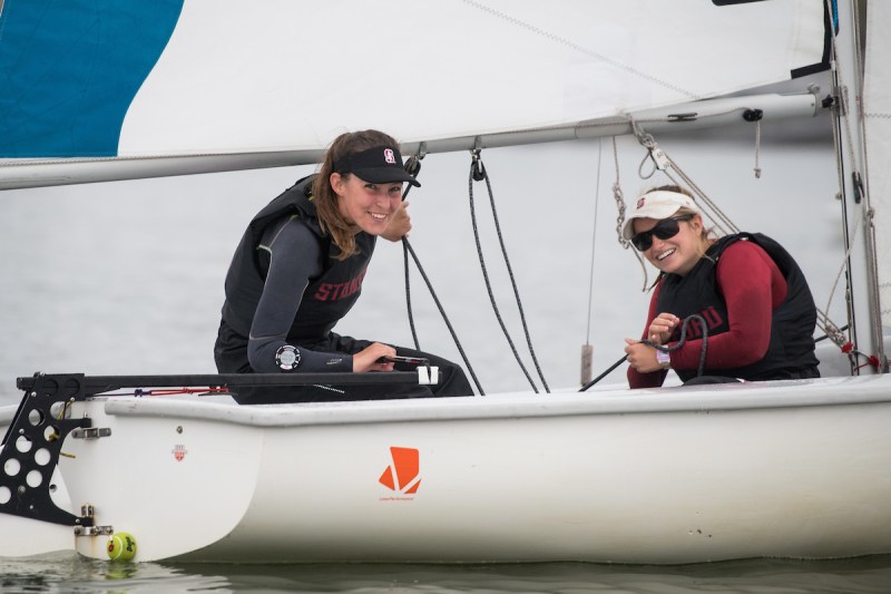 Stanford sailers Hannah Freeman and Abigail Tindall sit aboard their boat.