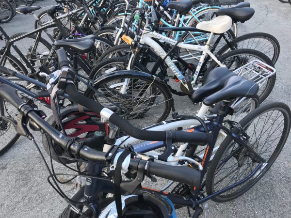 two bikes locked together at a crowded bike rack