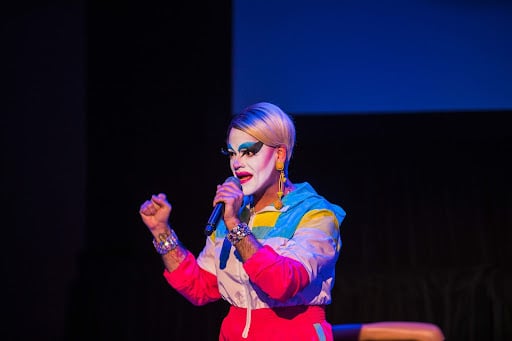 A photo of Rossi on stage in the "Karen" persona