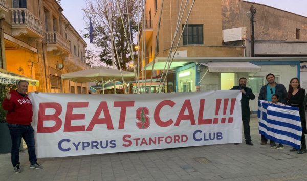 George Stavri '86 (right) and Kostas Koutentakis '87 (left) holding up a "BEAT CAL" banner in Cypress.