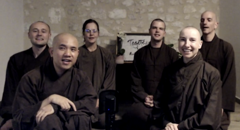 six buddhist monks in brown rows appear in a Zoom screenshot