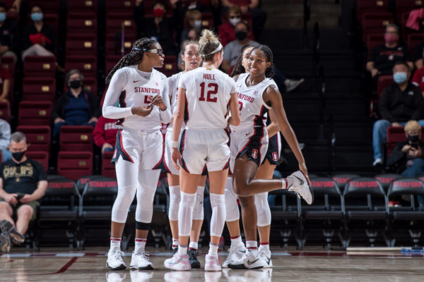 The Stanford women's basketball team gathers to talk during a break in the action.