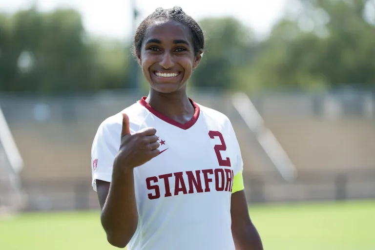 Naomi Girma smiles and gives a 'thumbs-up.'