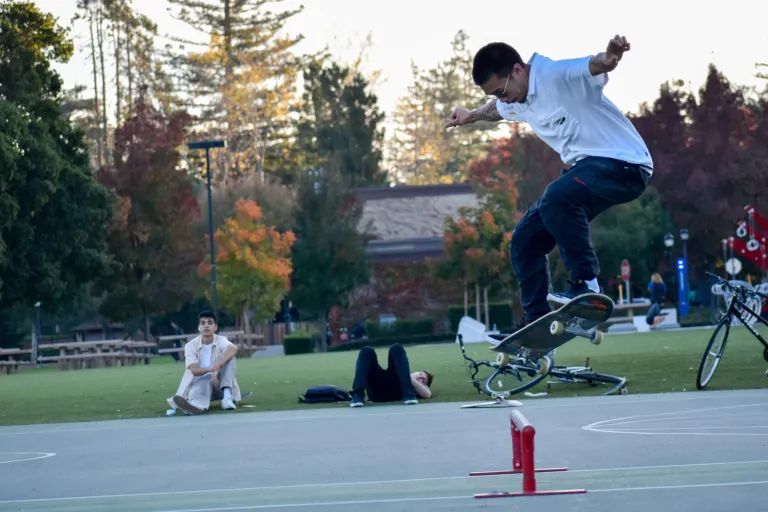 Christian Tocol jumps above a grind rail on the basketball courts on Wilbur Field.