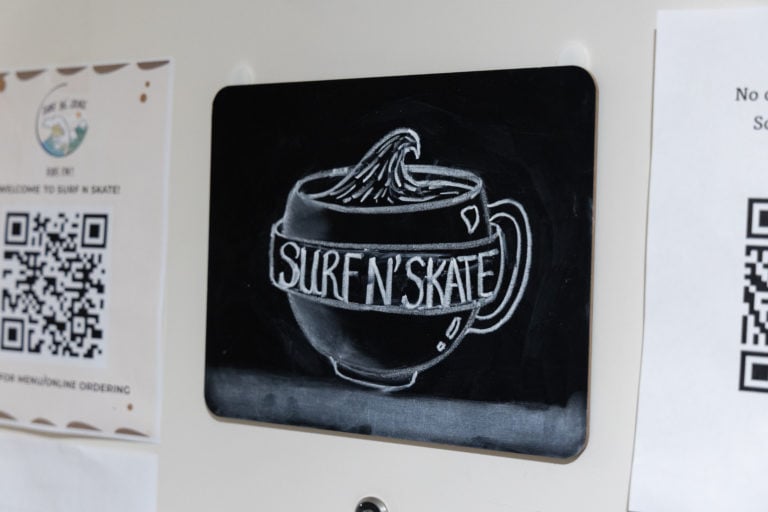 A photo of an drawing of a coffee cup with the words "surf n' skate" on it