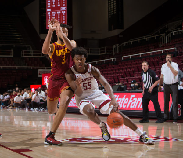 A Stanford basketball player drives to the basket