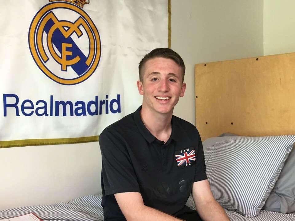 Eitan Weiner sits on his bed in his dorm room