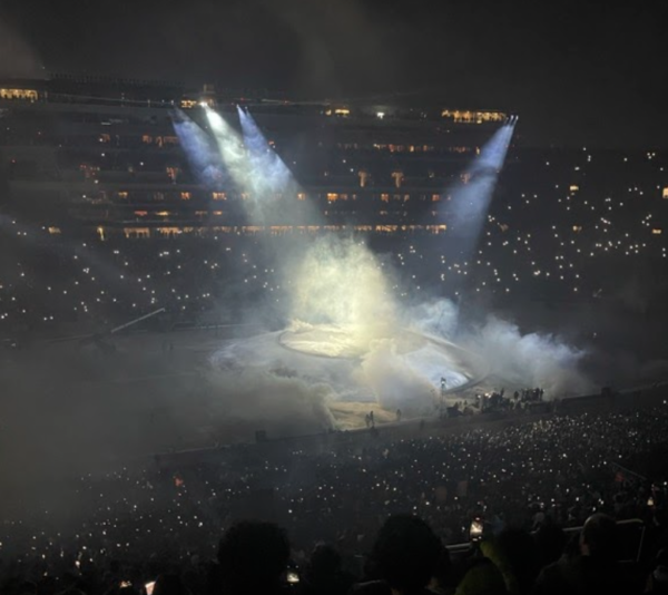 A concert stage under bright white lights.