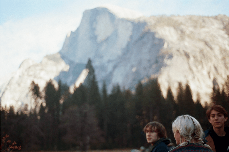 A group of Stanford students admire Yosemite's Half Dome.