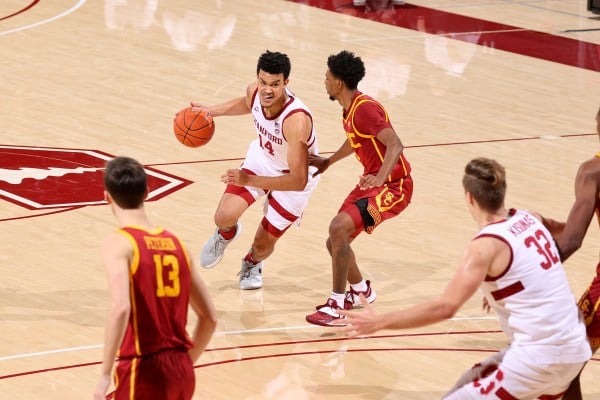 Spencer Jones drives with the ball against a USC player.