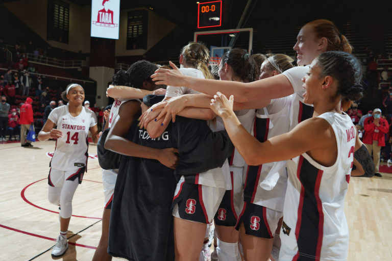 Stanford women's basketball players embrace head coach Tara VanDerveer