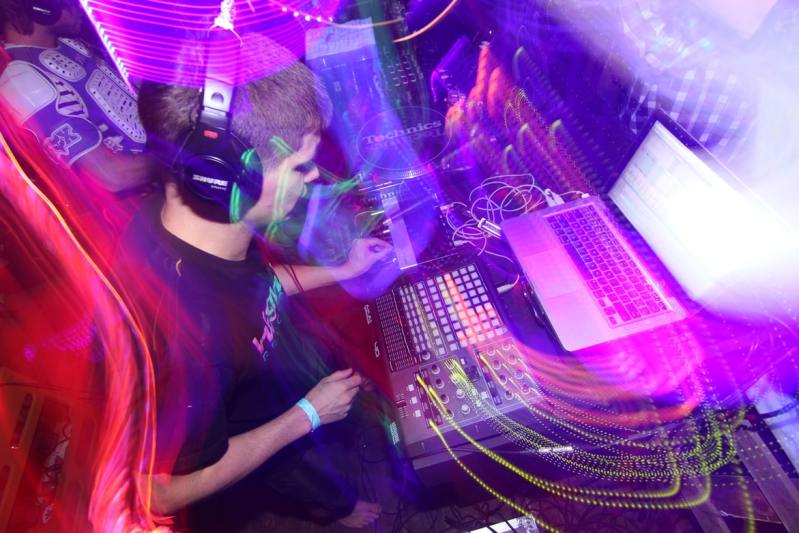 Blurred scenes of a DJ at a party with multi-colored lights.
