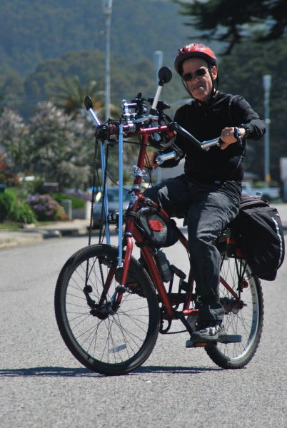 Professor Richard Reis rides his Full Body Bicycle