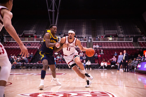 A player drives to the basket with a defender on the side of him