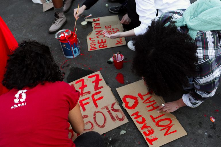 Stanford protestors create signs during their Pence Event protest