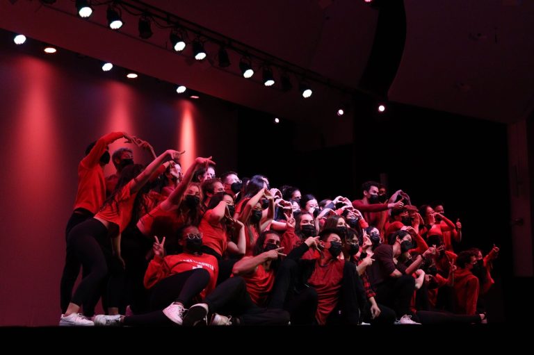 A group of dancers in red light