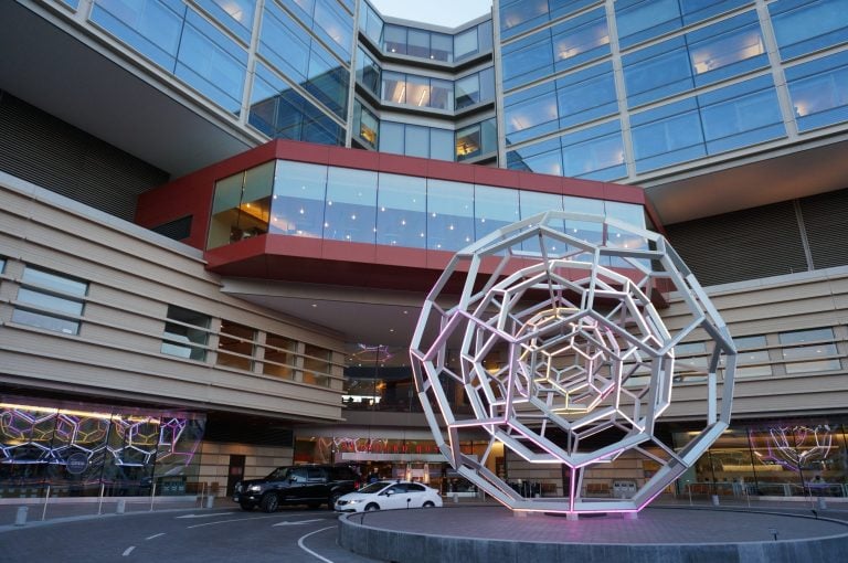 A geometric structure sits in front of the Stanford Hospital.