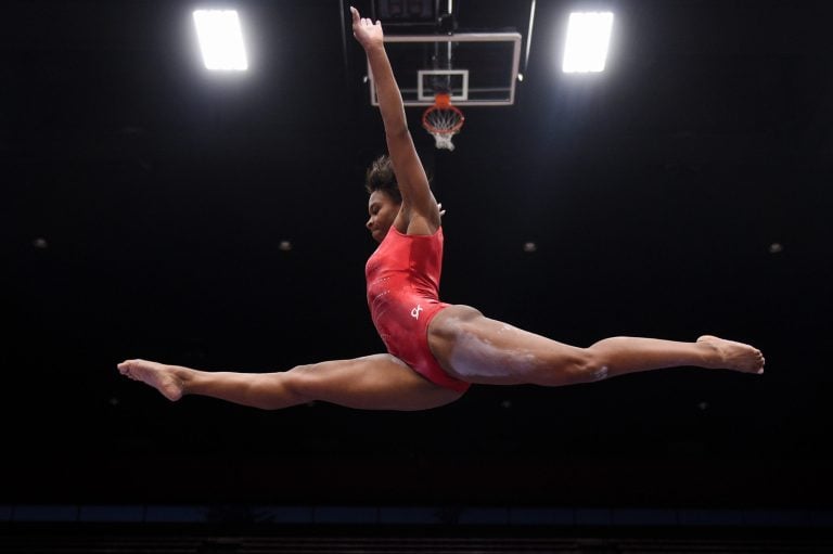 A gymnast does the splits in the air during the floor exercise.