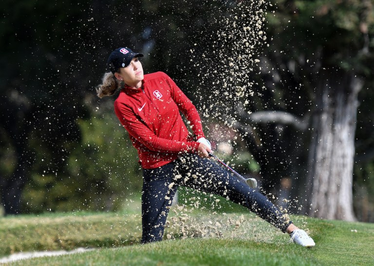 Sophomore Rachel Heck blasts out of a greenside bunker.