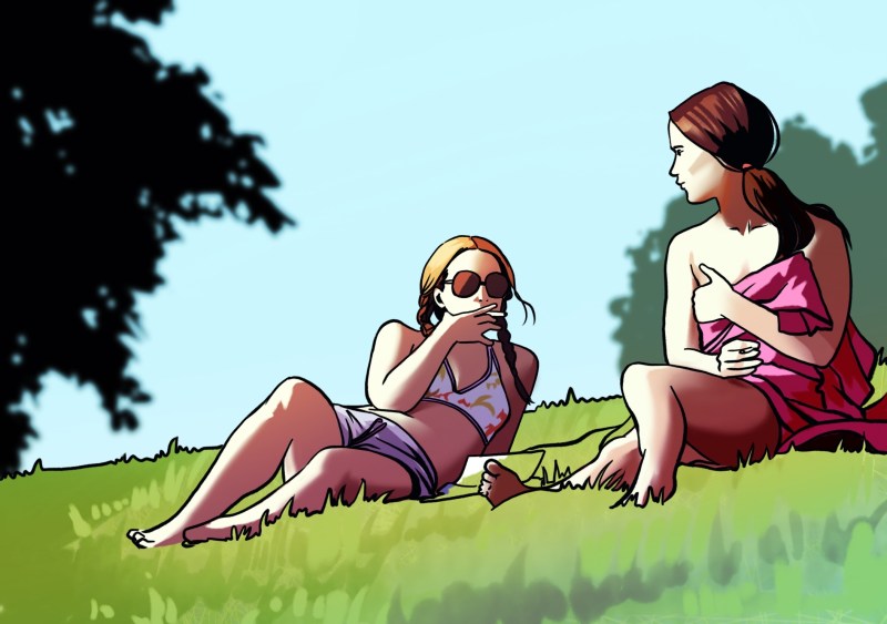 A blonde girl wearing a bikini reclines on a grassy field and smokes as she talks to a brunette girl wearing a towel.