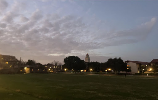 Sunset over Wilbur Field. Several dorm complexes and Hoover Tower can be seen in the distance.