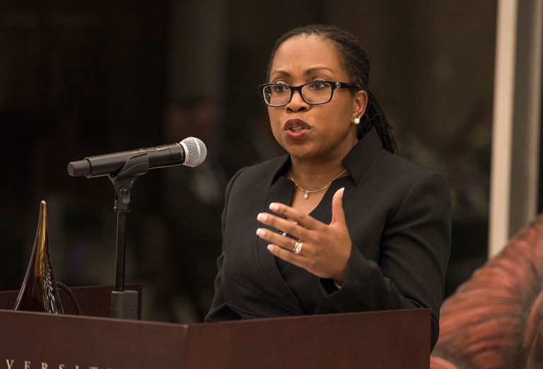 Judge Ketanji Brown Jackson speaking on a podium with an attached microphone