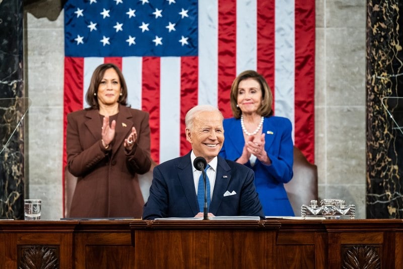 Biden speaks during his 2022 State of the Union speech, flanked by VPOTUS Harris and Speaker of the House Pelosi