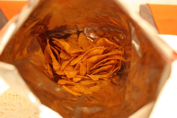 Looking down the center of an orange bag of Doritos.