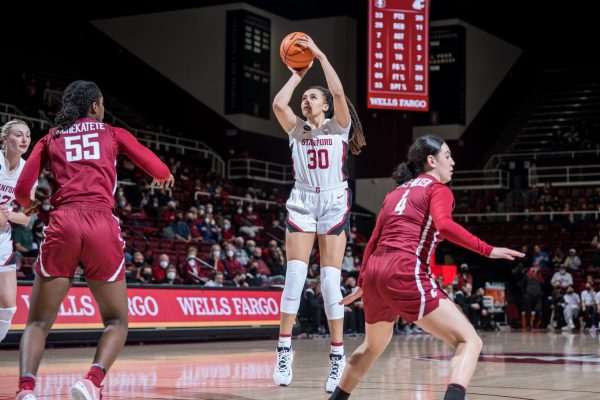 Haley Jones takes a shot with several Washington State defenders in front of her.