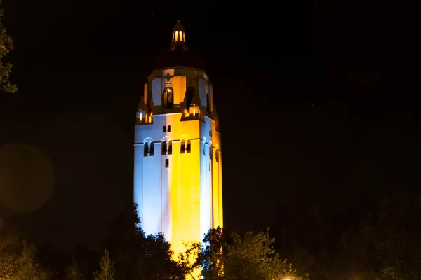 Hoover Tower lit in blue and yellow