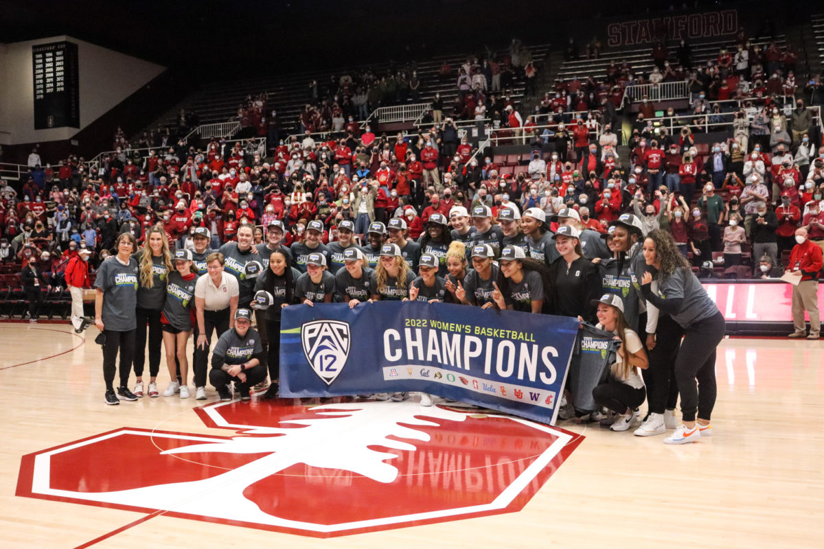 The entire team poses with the Pac-12 champions banner.