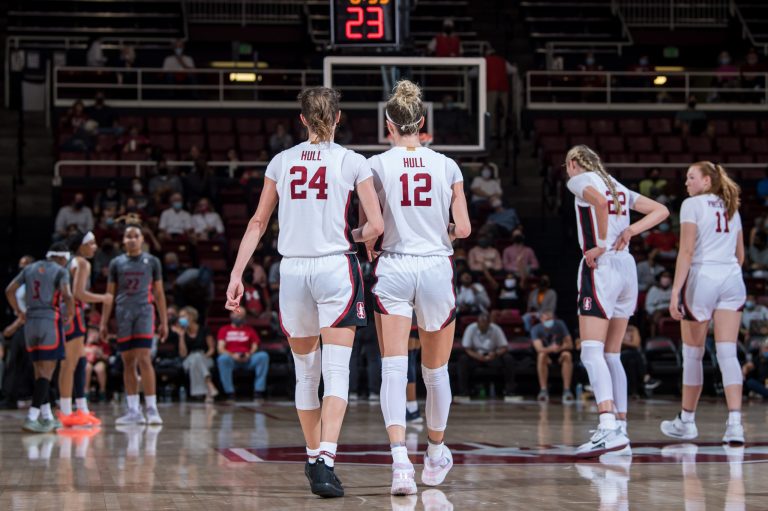 Lexie and Lacie Hull walk down the court together during a game.